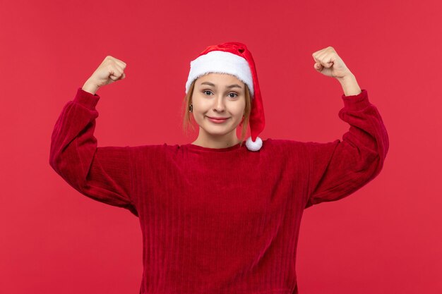Front view young female smiling and flexing, christmas holiday red