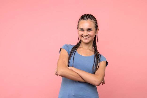 Front view of young female smiling on pink