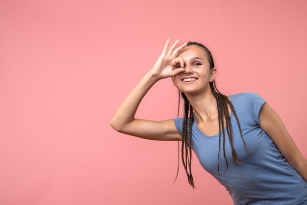 Free photo front view of young female smiling on pink