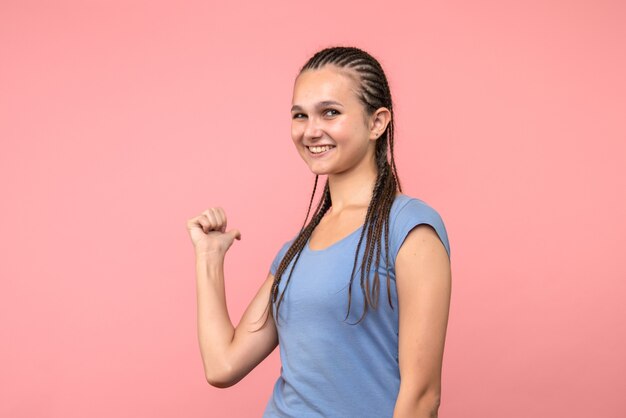 Front view of young female smiling on pink