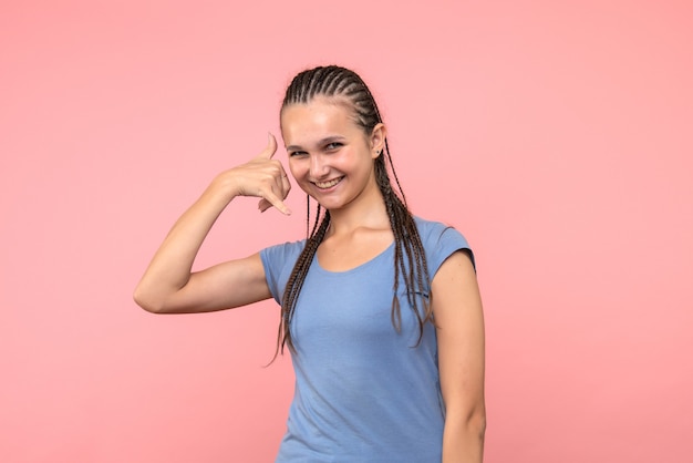 Front view of young female smiling on pink