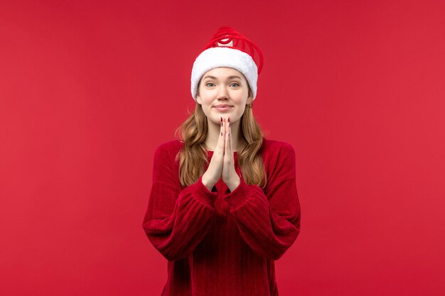 Front view young female smiling and praying, christmas holiday