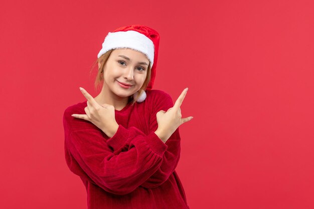 Front view young female smiling with rocker pose, holiday christmas red