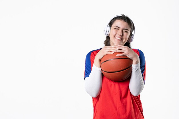 Front view young female in sport clothes with basketball