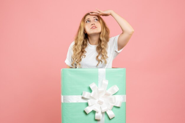 Free photo front view young female standing inside blue present box