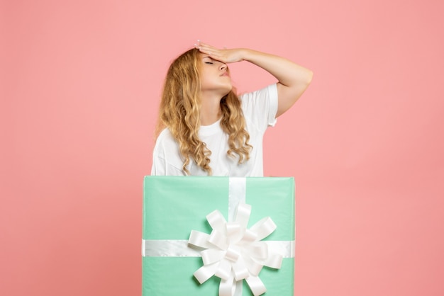 Free photo front view young female standing inside blue present box