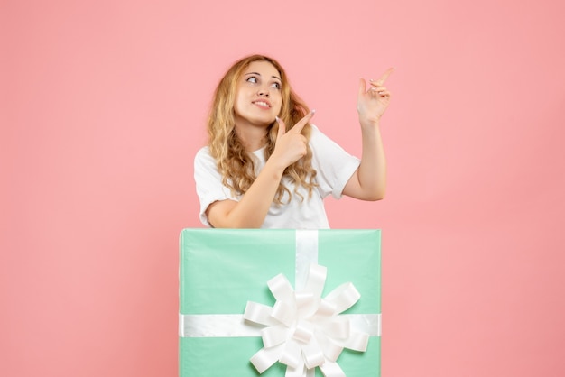 Front view young female standing inside present box