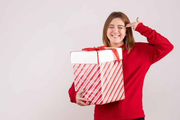 Free photo front view young female standing with present in her hands