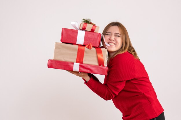 Front view young female standing with presents in her hands