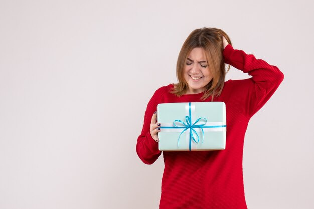 Front view young female standing with xmas present