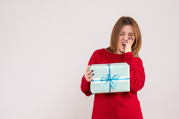 Front view young female standing with xmas present