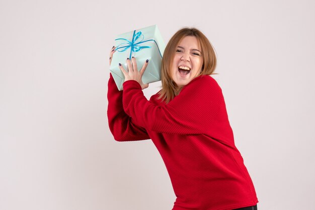 Front view young female standing with xmas present