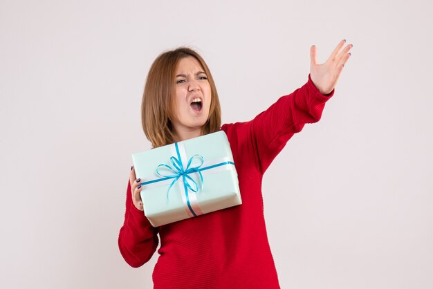 Front view young female standing with xmas present