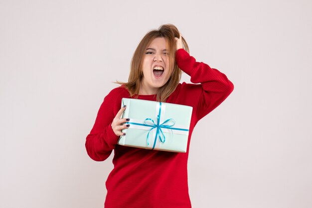 Front view young female standing with xmas present