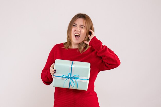 Front view young female standing with xmas present