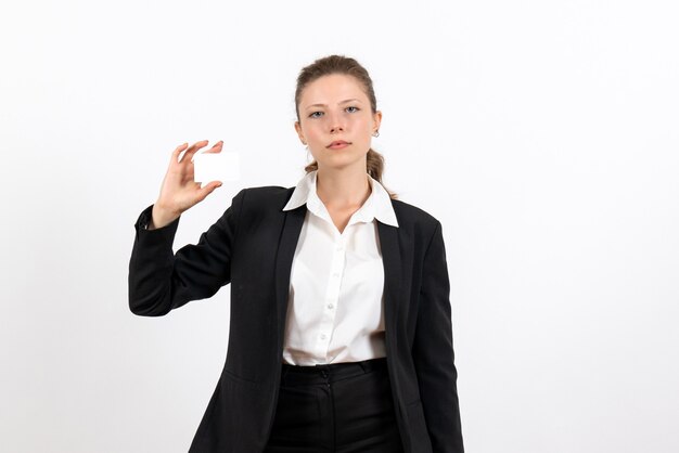 Front view young female in strict classic suit holding white card on the white background job business female work costume woman