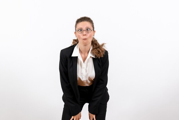 Front view young female in strict classic suit looking with funny expression on white background woman job business costume female work