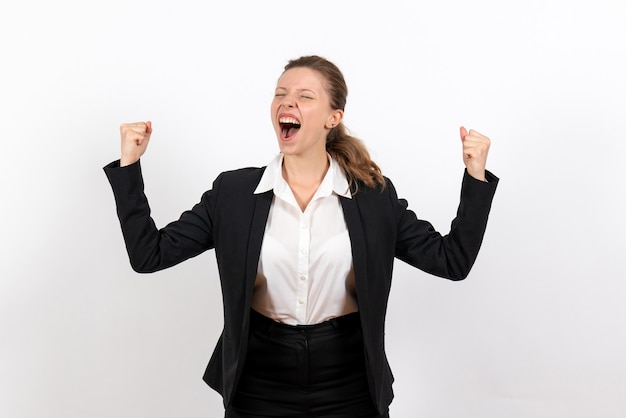 Front view young female in strict classic suit posing and rejoicing on white background job business costume woman work