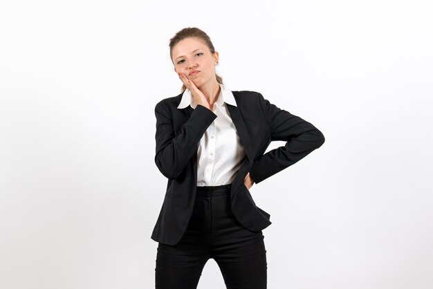 Front view young female in strict classic suit posing and thinking on white background woman business suit work job female