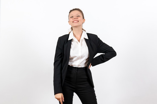 Front view young female in strict classic suit posing on the white background costume business job woman work female