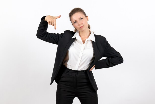 Front view young female in strict classic suit posing on white background costume business job woman work female