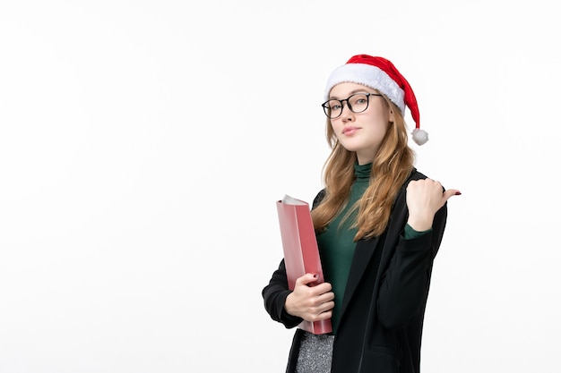 Front view young female student with files on a white wall book school college