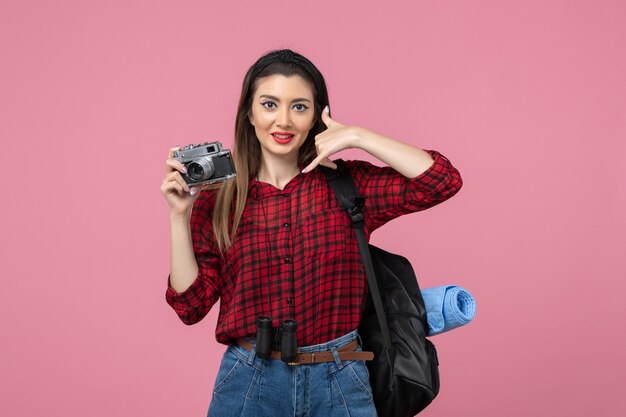 Front view young female taking picture with camera on pink background woman photo color