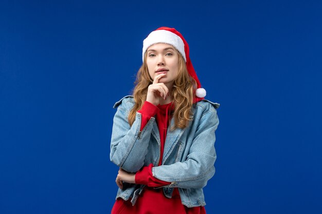 Front view young female thinking on a blue background color emotion christmas holiday