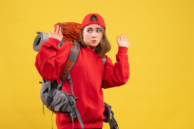 Front view young female traveler with backpack raising hands