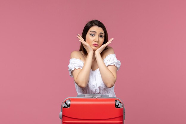 Front view young female in vacation posing on pink background abroad sea journey travel trip voyage