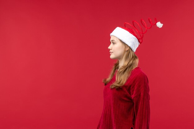 Front view young female wearing christmas cap, holiday red woman