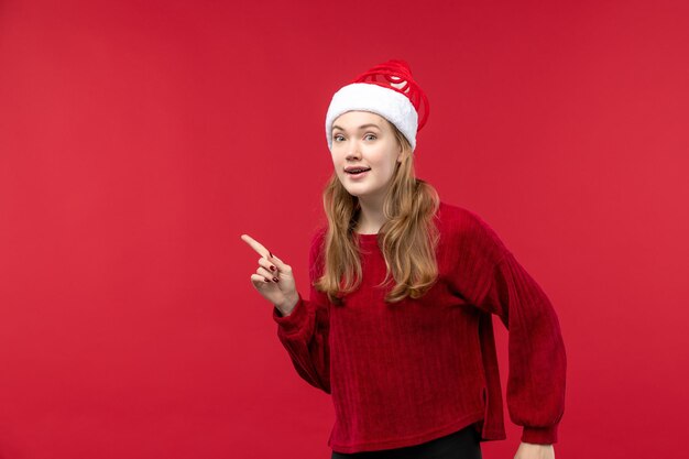 Free photo front view young female wearing christmas santa hat, holidays red woman