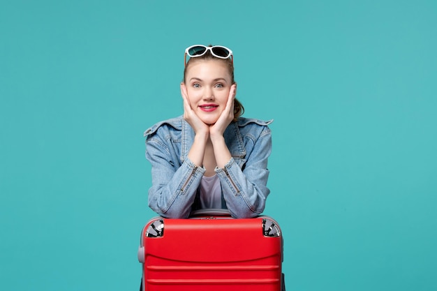 Front view young female with bag preparing for vacation on a blue space