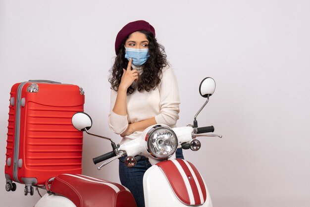 Front view young female with bike in mask on white background virus vehicle speed covid- road color pandemic