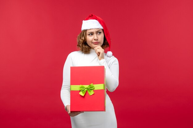赤でクリスマスプレゼントと若い女性の正面図