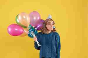 Free photo front view young female with colorful balloons