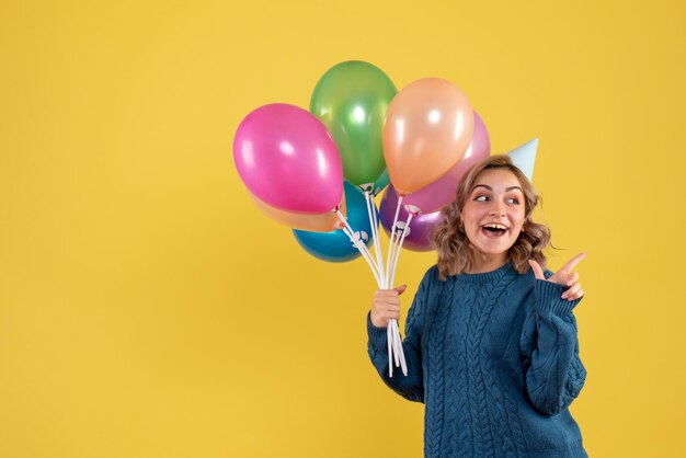 Front view young female with colorful balloons