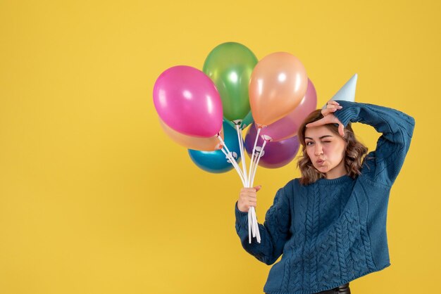 Front view young female with colorful balloons