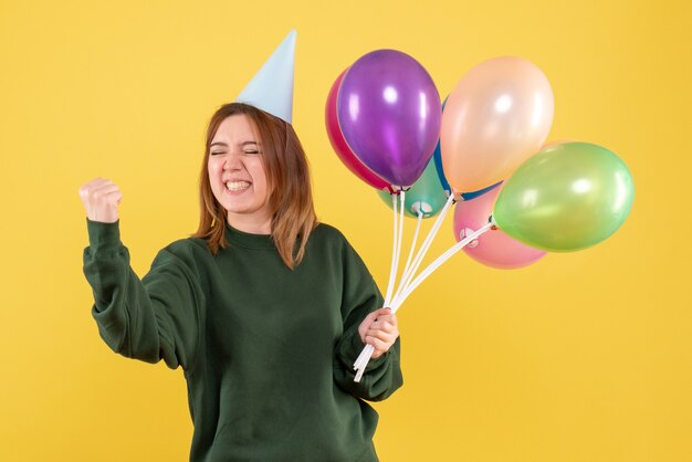 Front view young female with colorful balloons