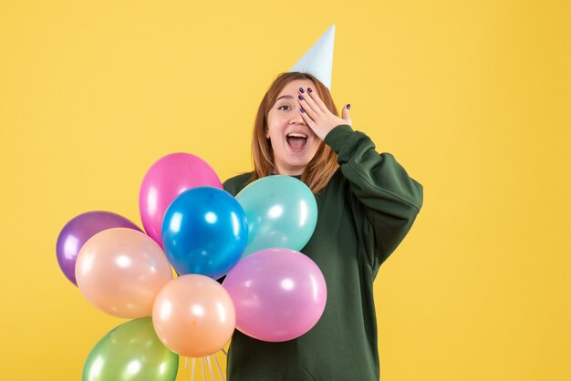 Front view young female with colorful balloons