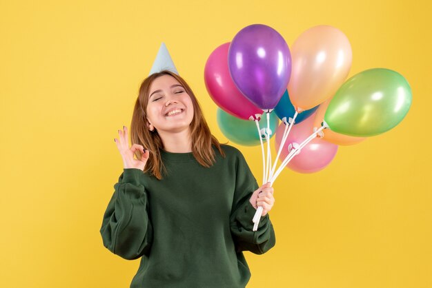 Front view young female with colorful balloons