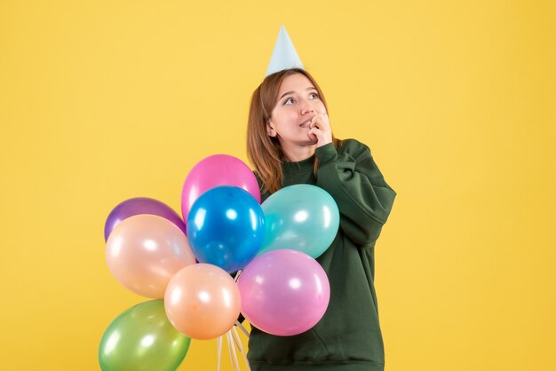 Front view young female with colorful balloons