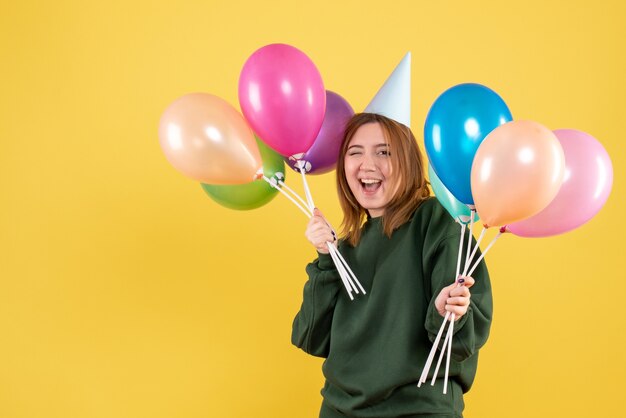 Front view young female with colorful balloons