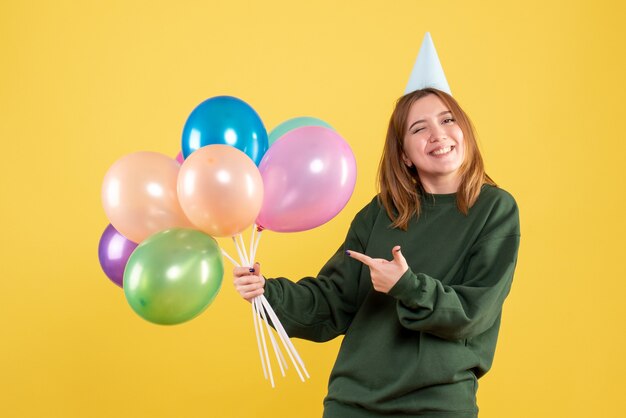 Front view young female with colorful balloons