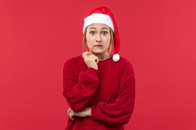 Front view young female with confused expression, holiday red christmas