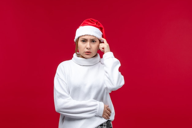 Front view young female with confused expression on red background