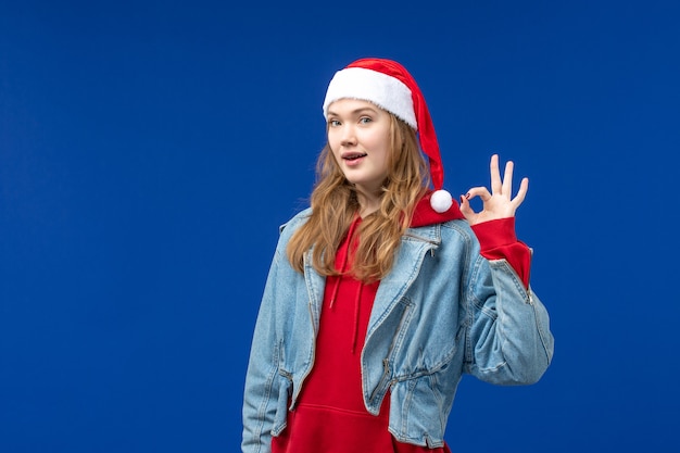 Front view young female with delighted expression on blue background christmas holiday emotion