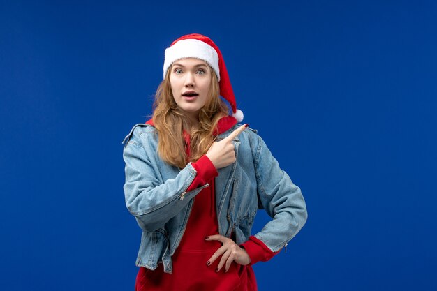 Front view young female with excited expression on the blue background new year holiday christmas