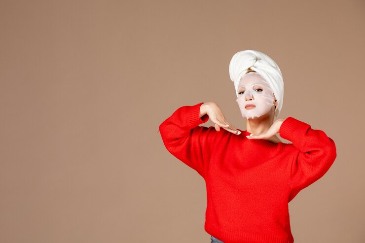 Free Photo front view young female with face mask on pink background