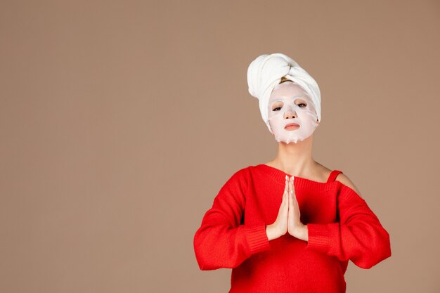 front view young female with face mask on pink background